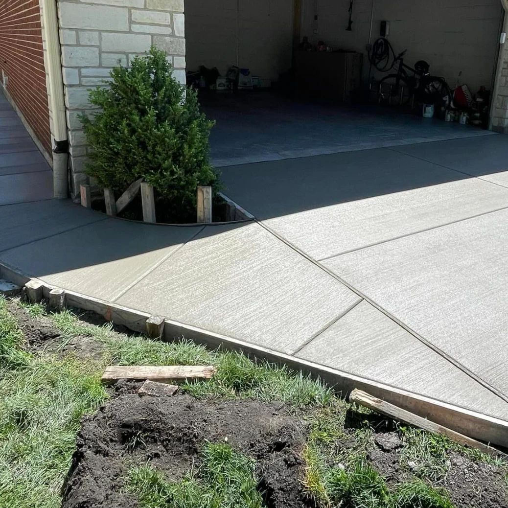 New concrete driveway with a walk along the side of the garage