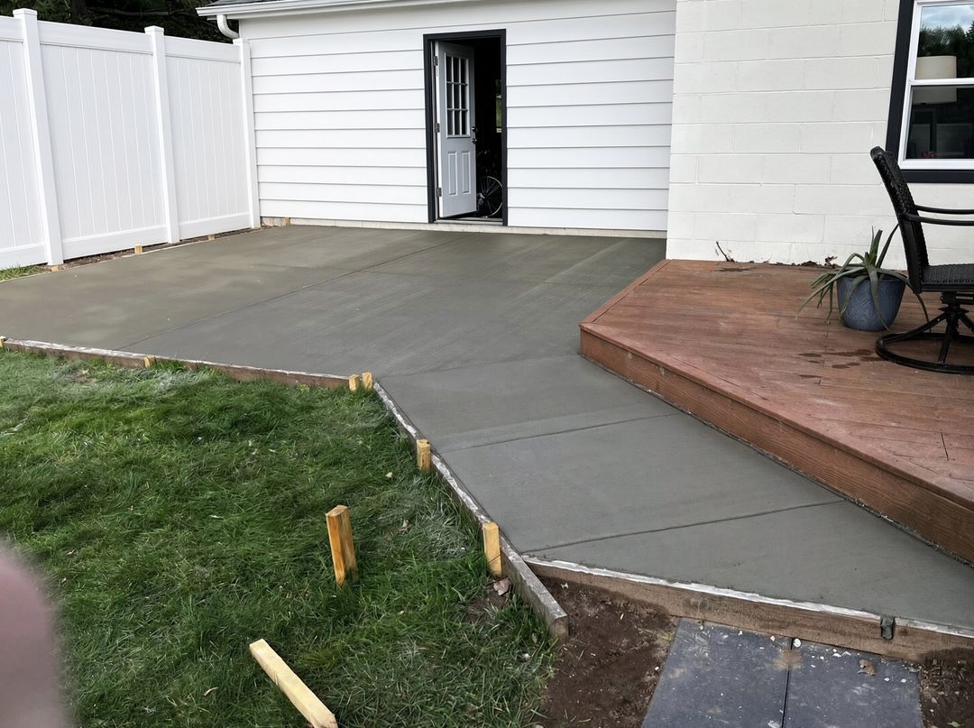 Broom finish concrete patio poured against a wood deck, Eau Claire WI