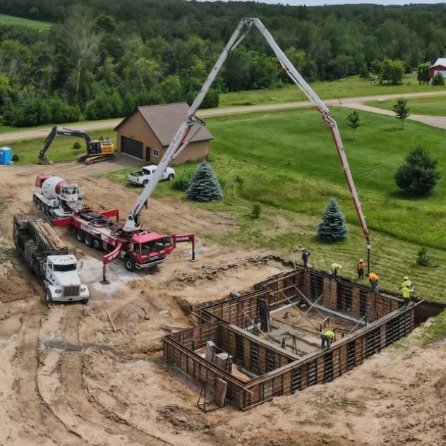 Concrete pump truck pouring foundation walls