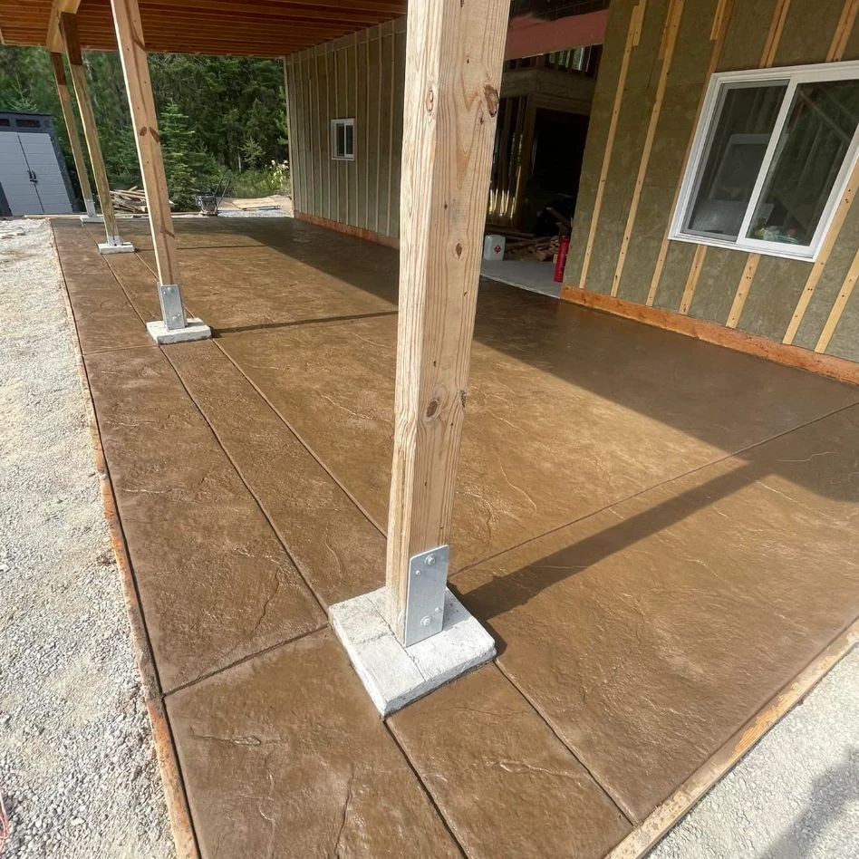 Brown stamped concrete slab under a deck